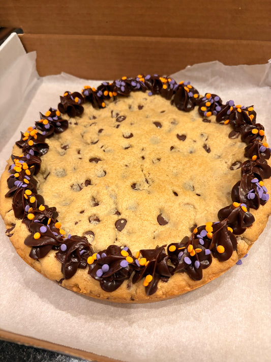 Chocolate chip cookie with decorative chocolate border in a box